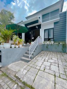 a house with potted plants in front of it at Villa RR in Bandungan