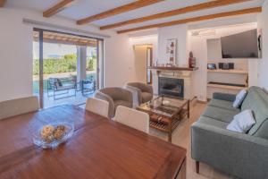 a living room with a couch and a table at G014 Paraiso by Mallorca Villa Selection in Alcudia