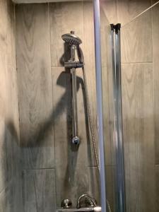 a shower in a bathroom with a shower head at Dobbin the horse box in The Lake District in Cockermouth