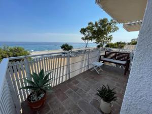 a balcony with a view of the ocean at The Greek’ House in Bova Marina