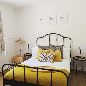 a bedroom with a bed with yellow pillows at Bryngwalia Fach in Cribyn