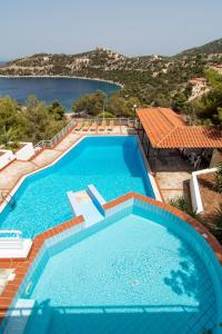 a large swimming pool with a view of the water at Oasis Resort in Pefkali