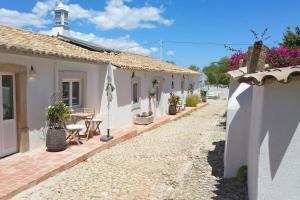 a house with a patio with a table and chairs at Vila Lobo Algarve in Faro