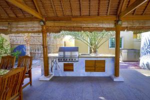 an outdoor kitchen with a stove in a patio at Dar 66 Pool Villa with Jacuzzi in Ras al Khaimah