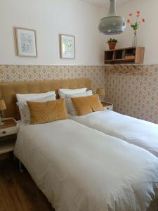 two beds sitting next to each other in a bedroom at Villa Warempel in Valkenburg