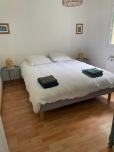 a bedroom with a bed with two towels on it at Ker valyan in Cancale