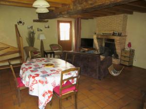 uma sala de estar com uma mesa e uma lareira em Maison de 2 chambres avec jardin amenage et wifi a Mardie em Mardié