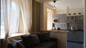 a living room with a couch and a kitchen at Classic 2-room apartment in old town Riga in Rīga