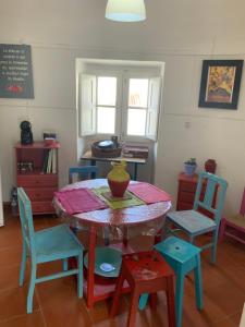 a table with chairs and a bowl on top of it at Ilha ALFRIDA in Carrapatelo +16 photos