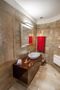a bathroom with a sink and a tub at Oasis Resort in Pefkali