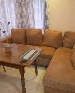 a living room with a couch and a coffee table at Stay.Plus Villa Serene Kitale in Kitale