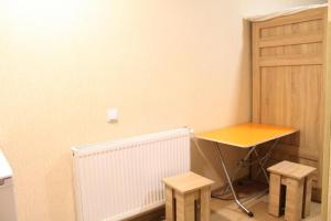 a small table and two stools in a room at Hotel White Bridge in Kutaisi