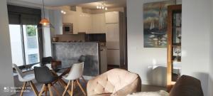 a kitchen and living room with a table and chairs at Appartement Baviera Hills - Torre del Mar - Costa del Sol in Caleta De Velez