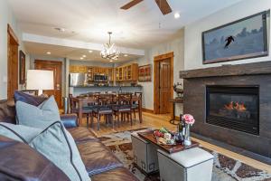 a living room with a fireplace and a dining room at 105 Pinecone Lodge in Edwards
