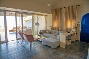a living room with a couch and a table at Oasis Resort in Pefkali