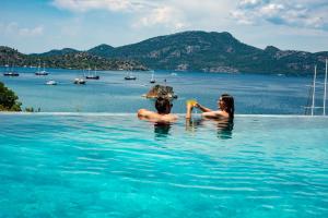 two people in the water in a swimming pool at Alice Tatil Evi in Marmaris