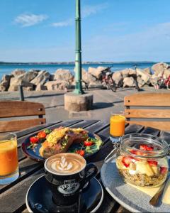 a table with a cup of coffee and food on it at Vila Piranesi Apartments in Piran
