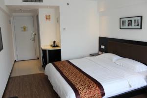 a bedroom with a bed and a telephone in it at Super 8 Beijing Chaoyang Road Xinglong in Beijing