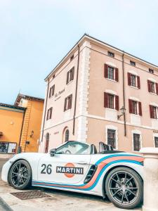 a white car parked in front of a building at Vila Piranesi Apartments - Parking included in Piran