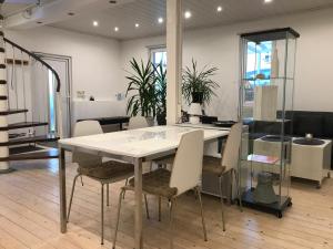 a dining room with a white table and chairs at Gästehaus pack of patches in Jena