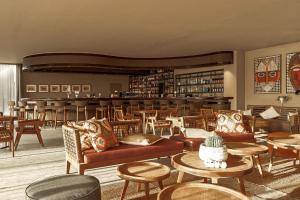 a lobby with couches and tables and a bar at Cook's Club Corfu - Adults Only in Gouvia