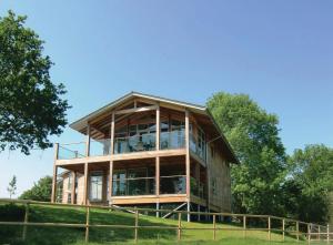a house on a hill with trees in the background at Apple Tree Lodges in Colchester