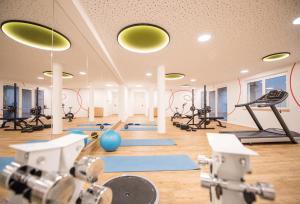 a gym with a lot of exercise equipment in a room at Vierbrunnenhof in Anterselva di Mezzo