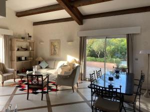 a living room with a table and a couch at Les cigales in Saint-Raphaël
