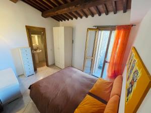 a bedroom with a large bed and a bathroom at Il Poggio da Katia in Saturnia