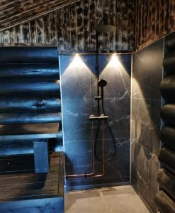 a bathroom with a shower with blue walls at Heteranta, Lake Inari / Inarijärvi in Inari