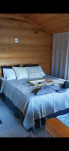 a large bed with a wooden headboard in a room at Heteranta, Lake Inari / Inarijärvi in Inari