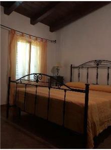 a large bed in a bedroom with a window at Il Nido delle Gazze in Marina di Camerota