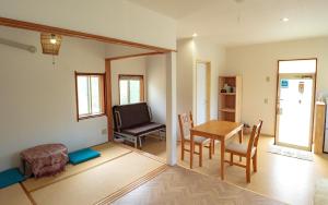 a living room with a table and a chair at Ikokujyoucho - Vacation STAY 35774v in Nishinoomote