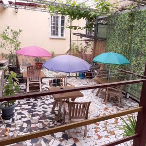 a patio with tables and umbrellas on a patio at Shanson in Gagra