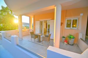 a balcony of a house with a table and chairs at Artemis No1 Apartment in Kissamos