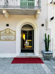 a front door of a grand hotel with a cactus at PFA Hotel Viareggio in Viareggio