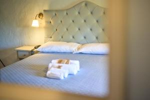 a hotel room with a bed with two towels on it at Hotel Relais San Lorenzo in Abbadia San Salvatore