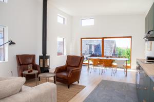 a living room with a couch and chairs and a table at Rösholmens Havsboende in Kungshamn