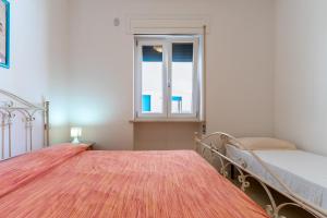 a bedroom with two beds and a window at Residence La Perla - Ametista in Pizzo