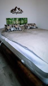 a large bed sitting in a room with at Grüne Glocke in Altenau
