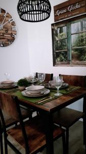 a dining room table with plates and glasses on it at Grüne Glocke in Altenau