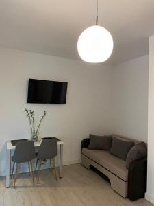 a living room with a couch and a table at Blue Bike Residence Mamaia Studio in Mamaia