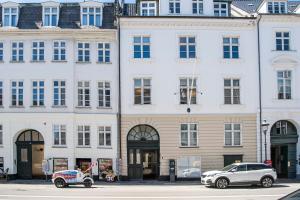 two cars parked in front of a building at The Churchill apartments by Daniel&Jacob's in Copenhagen