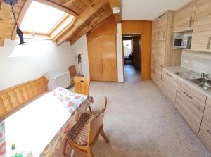 a kitchen with a table and chairs in a room at Haus-Bucheneck-Wohnung-Sonnenaufgang in Oberstdorf