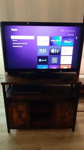 a flat screen tv sitting on top of a wooden stand at Grüne Glocke in Altenau