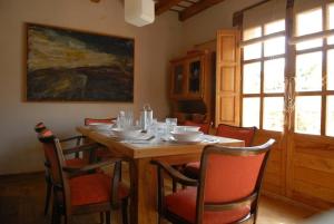 a dining room with a wooden table and chairs at La Casuca de Agüero in Agüero