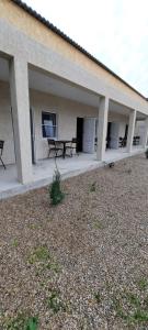 a building with benches and tables in a courtyard at Пограничная 8 in Kheivani