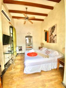 a bedroom with a bed and a dresser at Hotel Boutique Castillo Ines Maria in Cartagena de Indias