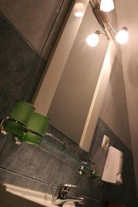 a bathroom with a mirror and a sink at Hotel Pamira in Sibiu