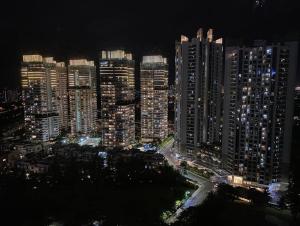 a night view of a city with tall buildings at 3BR apt Springhill Terrace, golf view in Jakarta